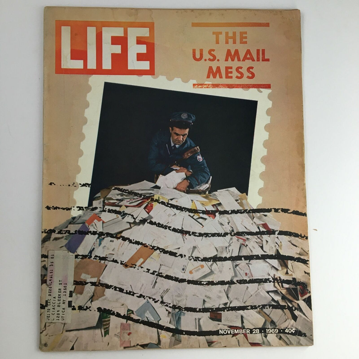 Cover of Life Magazine from November 28, 1969 titled 'The U.S. Mail Mess', featuring a postal worker surrounded by a pile of letters, illustrating challenges in the postal system during that era.