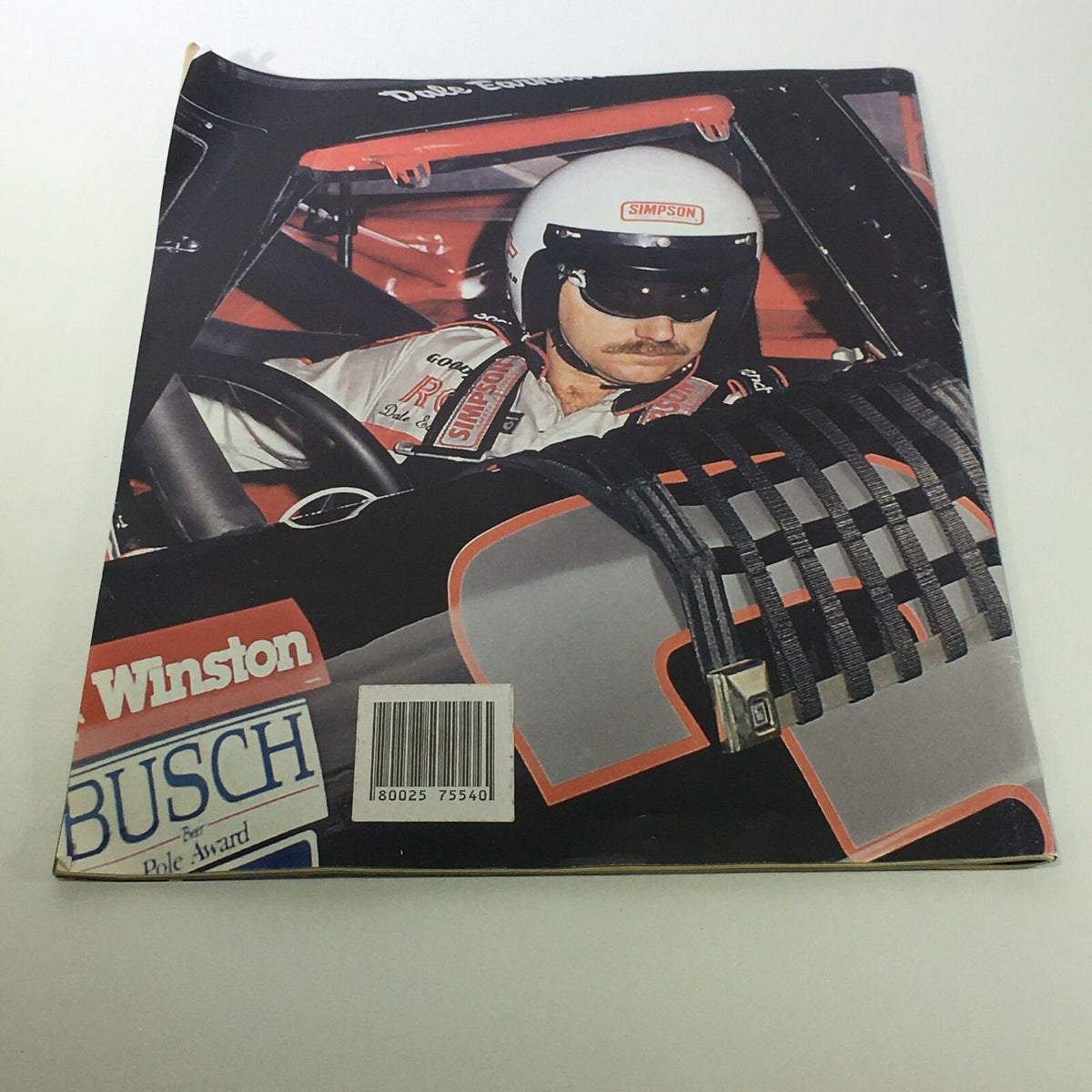 AMI Specials A Tribute to an American Hero Dale Earnhardt Magazine back cover depicting Dale Earnhardt driving a race car, highlighting the magazine's focus on the legendary driver.