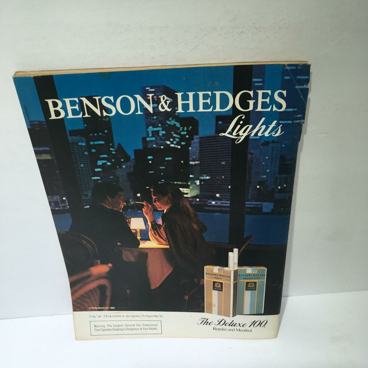 Ad for Benson & Hedges Lights showing a couple dining in a cityscape setting, featured in Time Magazine dated May 7, 1984.