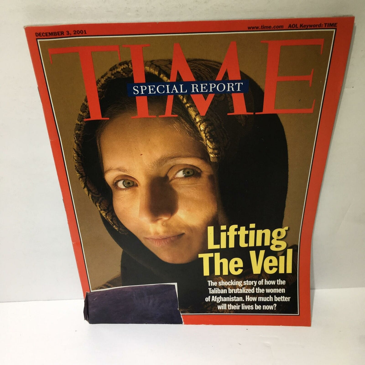 Alternate view of the Time Magazine cover from December 3, 2001, showcasing the headline 'Lifting The Veil', documenting the plight of women in Afghanistan under Taliban rule.