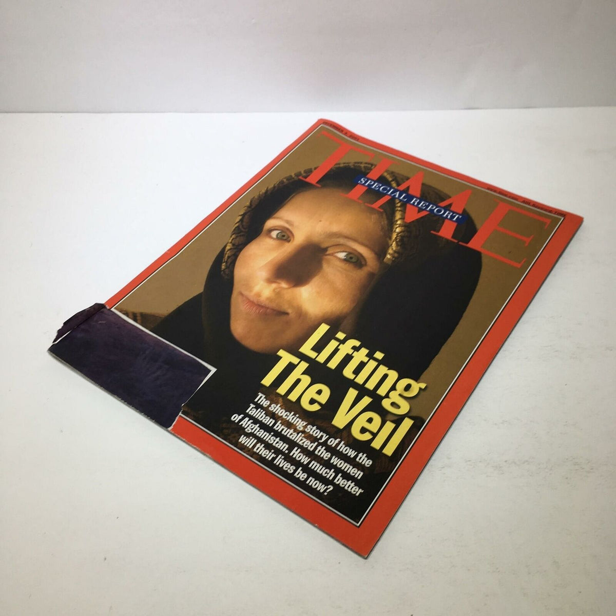 Front cover of Time Magazine, December 3, 2001, titled 'Lifting The Veil' highlighting the struggles of Afghan women during Taliban rule.