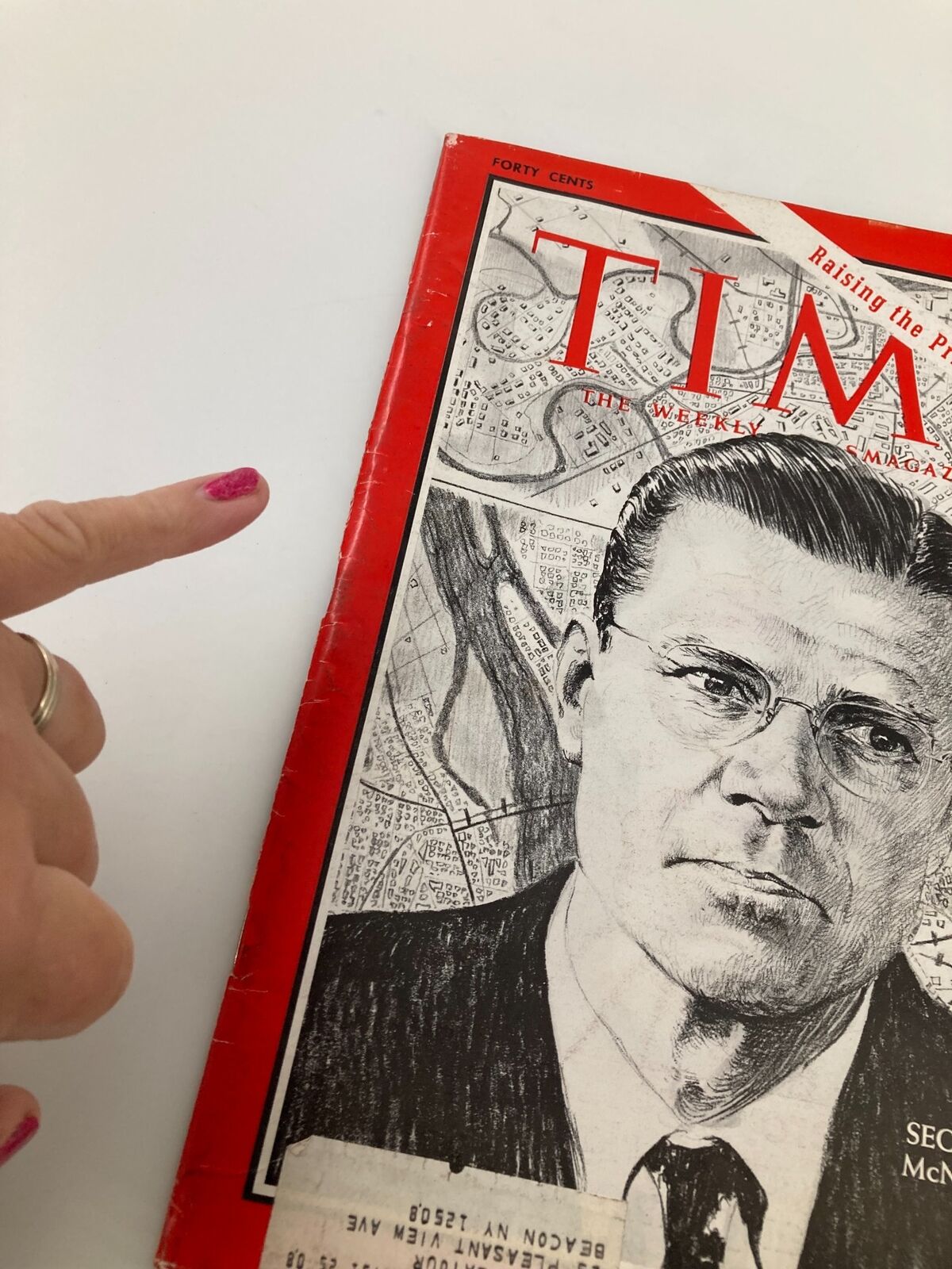 Close-up of the vintage Time Magazine cover from July 8, 1966, showing Secretary Robert McNamara, with a pointed finger indicating the magazine's details on Volume 88, Issue 2.