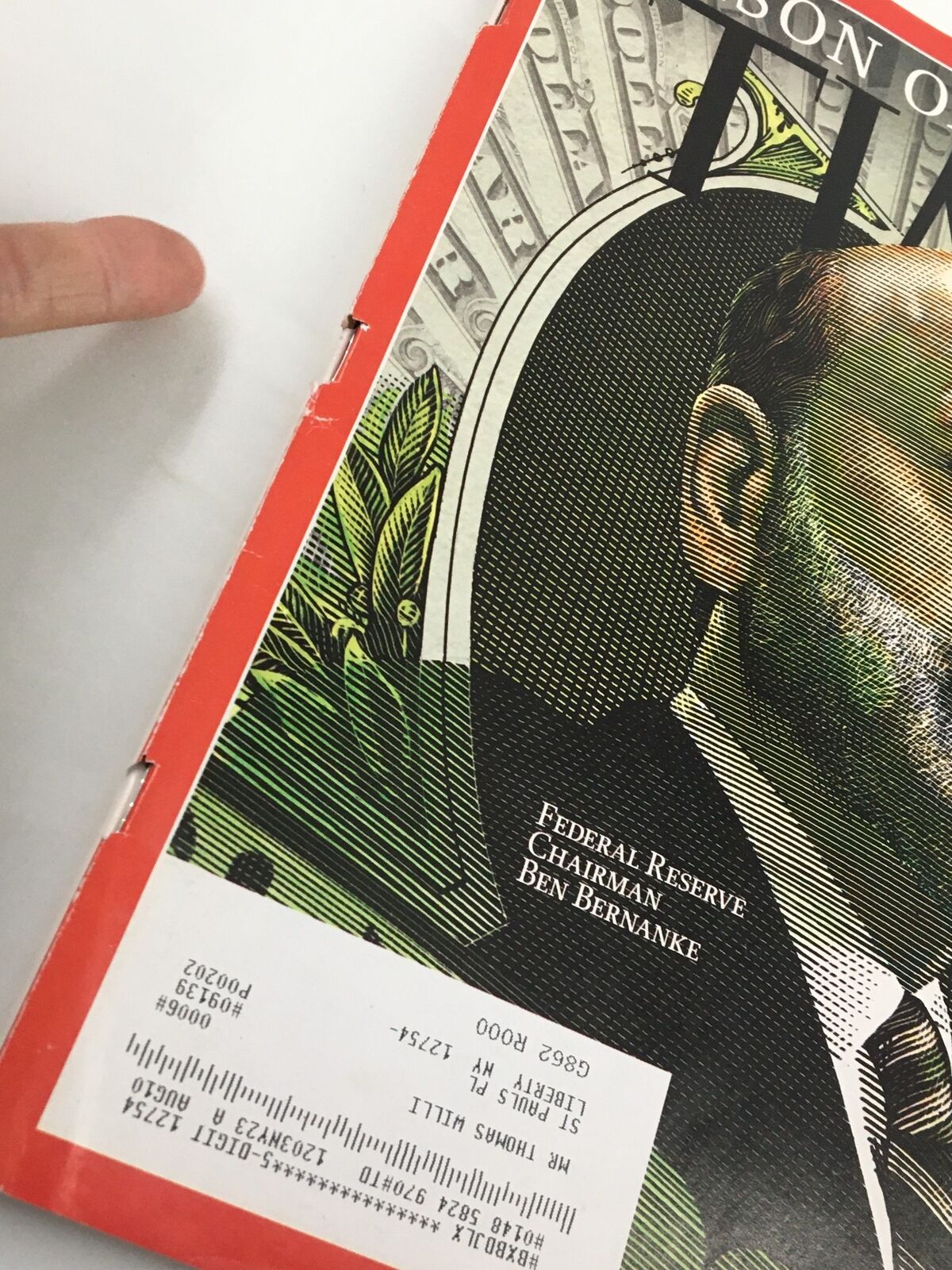 Close-up of the Time Magazine cover from December 28, 2009, with Federal Reserve Chairman Ben Bernanke, showing details of the magazine's protective covering and address label.