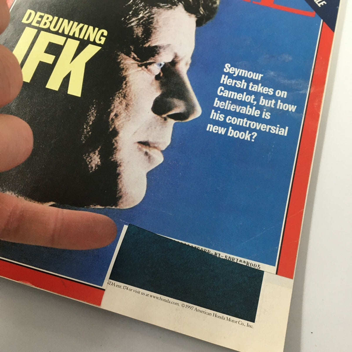 Close-up of the Time Magazine cover from November 17, 1997, titled 'Debunking JFK'. The image highlights the profile of John F. Kennedy and the text addressing Seymour Hersh's analysis of Kennedy's legacy.
