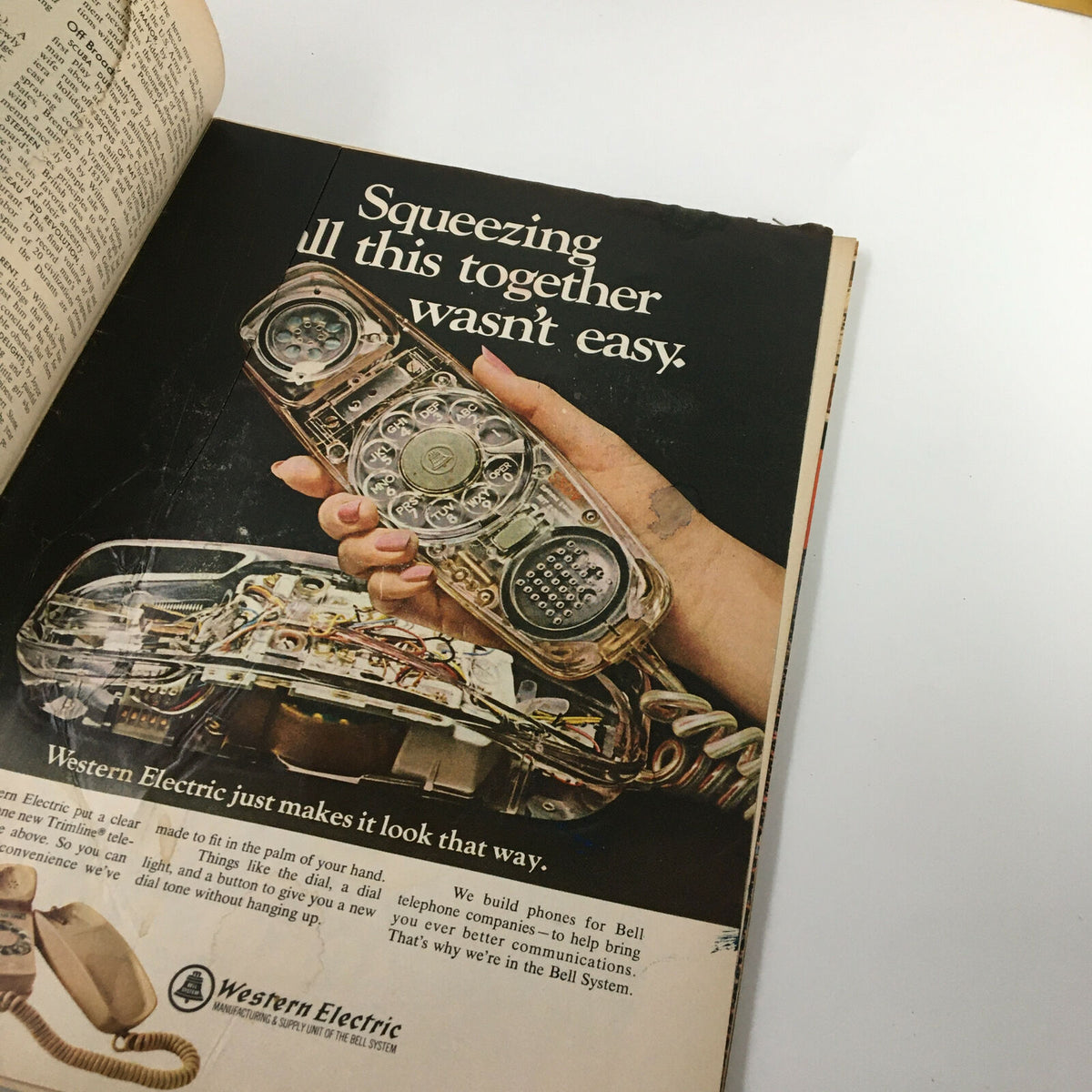 Vintage advertisement from VTG Time Magazine November 3, 1967, featuring a hand holding a Western Electric telephone with a caption 'Squeezing all this together wasn’t easy.' This ad highlights the intricate technology behind telephone design.