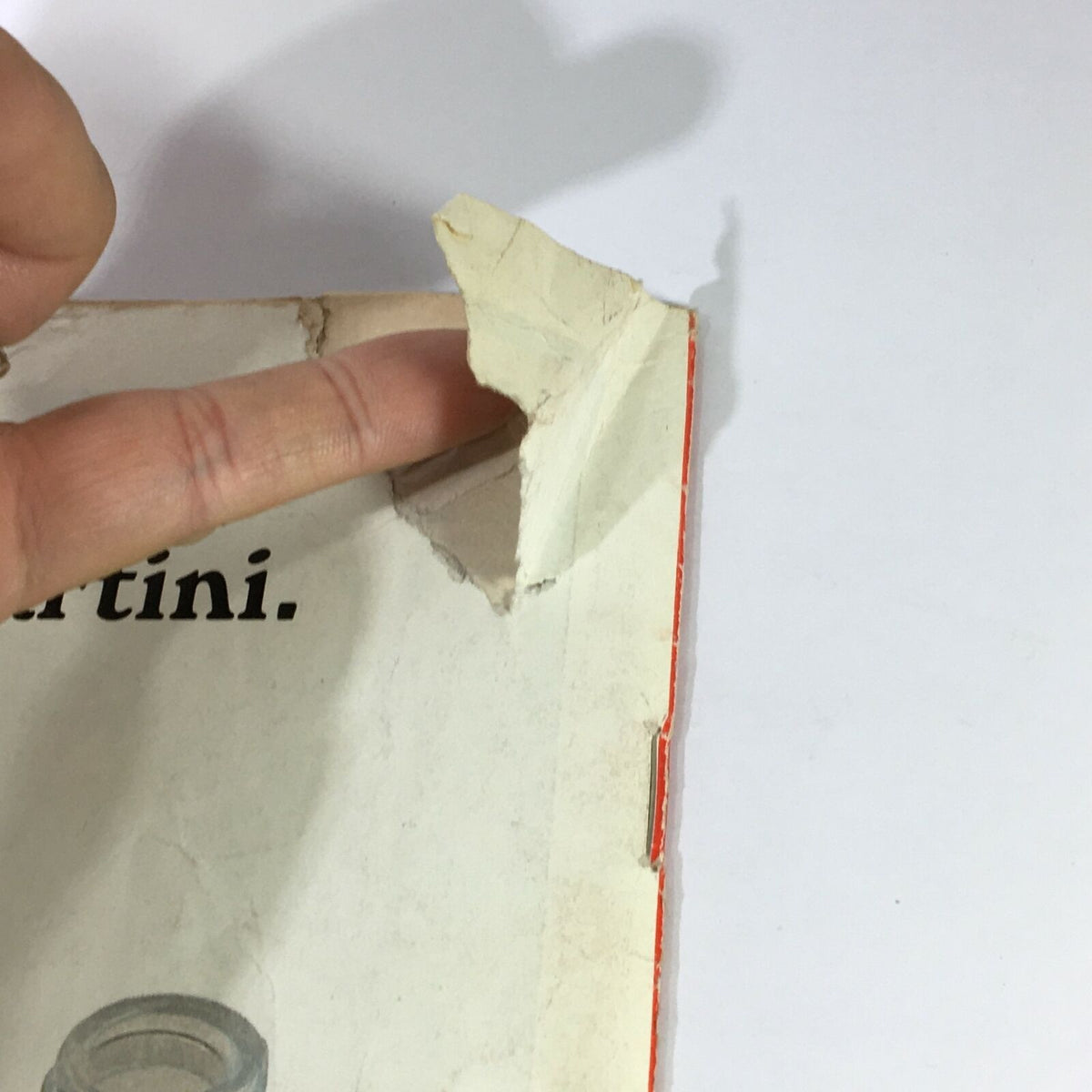 Close view of the torn corner of the Vintage Time Magazine June 30 1967, indicating its age and usage.