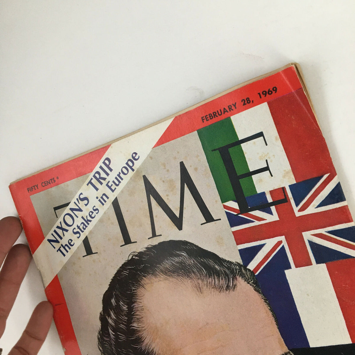Side view of Time Magazine from February 28 1969, showing the cover details including the title 'Nixon's Trip: The Stakes in Europe' and prominent flags.