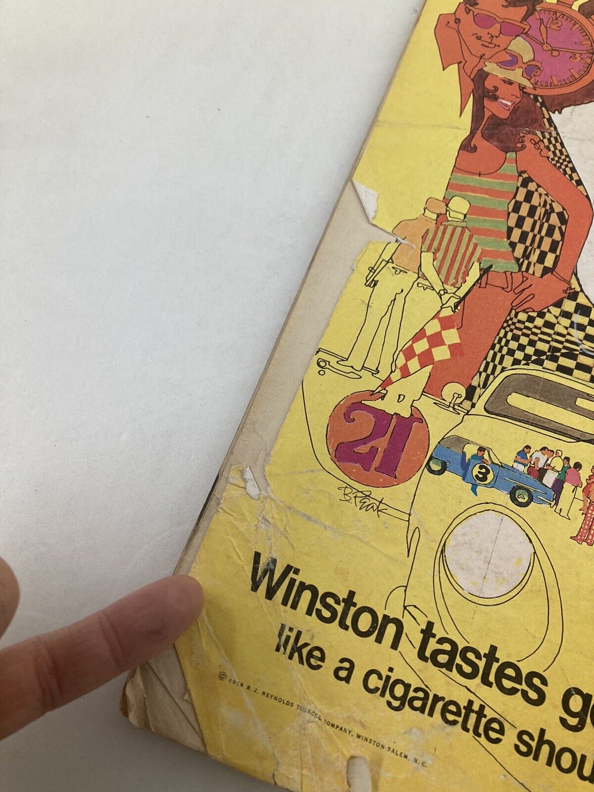 Back cover of a vintage advertisement depicting a woman in striped clothing with a vibrant design, promoting Winston cigarettes. The advertisement says 'Winston tastes good like a cigarette should,' reflecting the 1960s style.