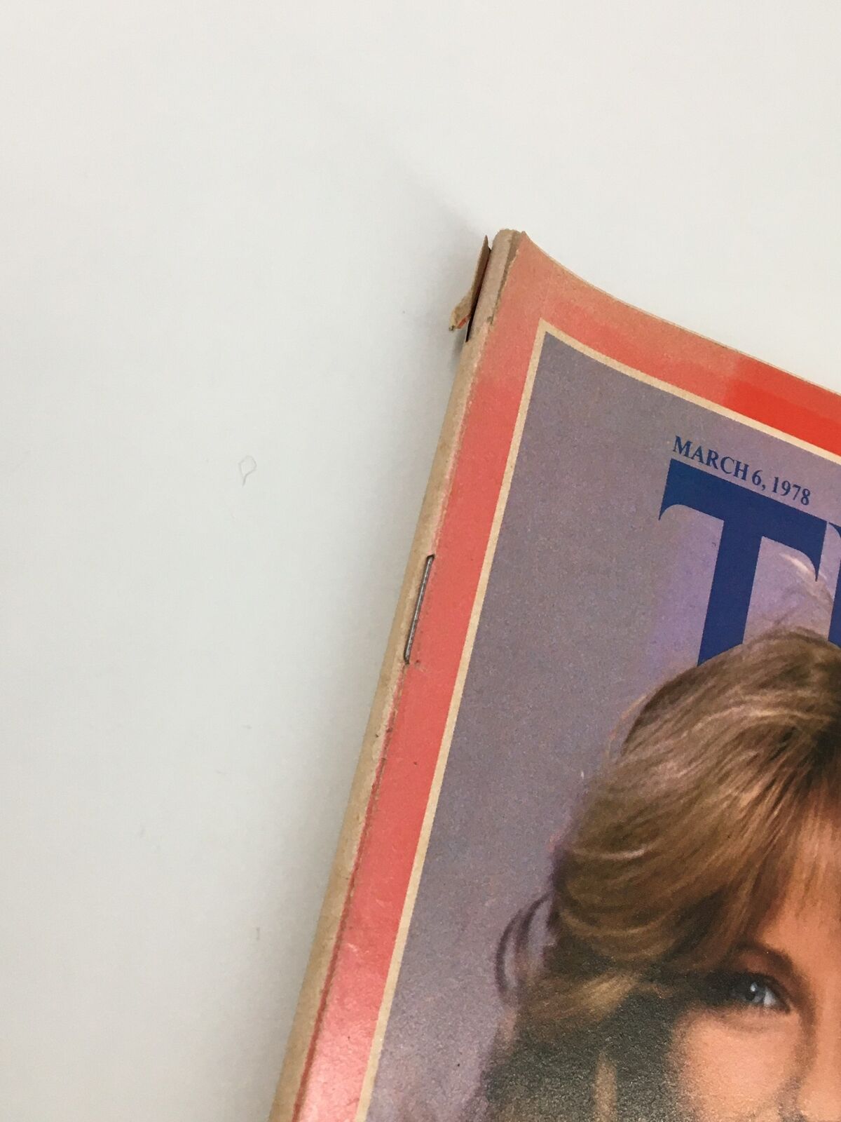 Close-up view of the spine of VTG Time Magazine from March 6, 1978, illustrating the vintage condition and wear of the issue featuring model Cheryl Tiegs.