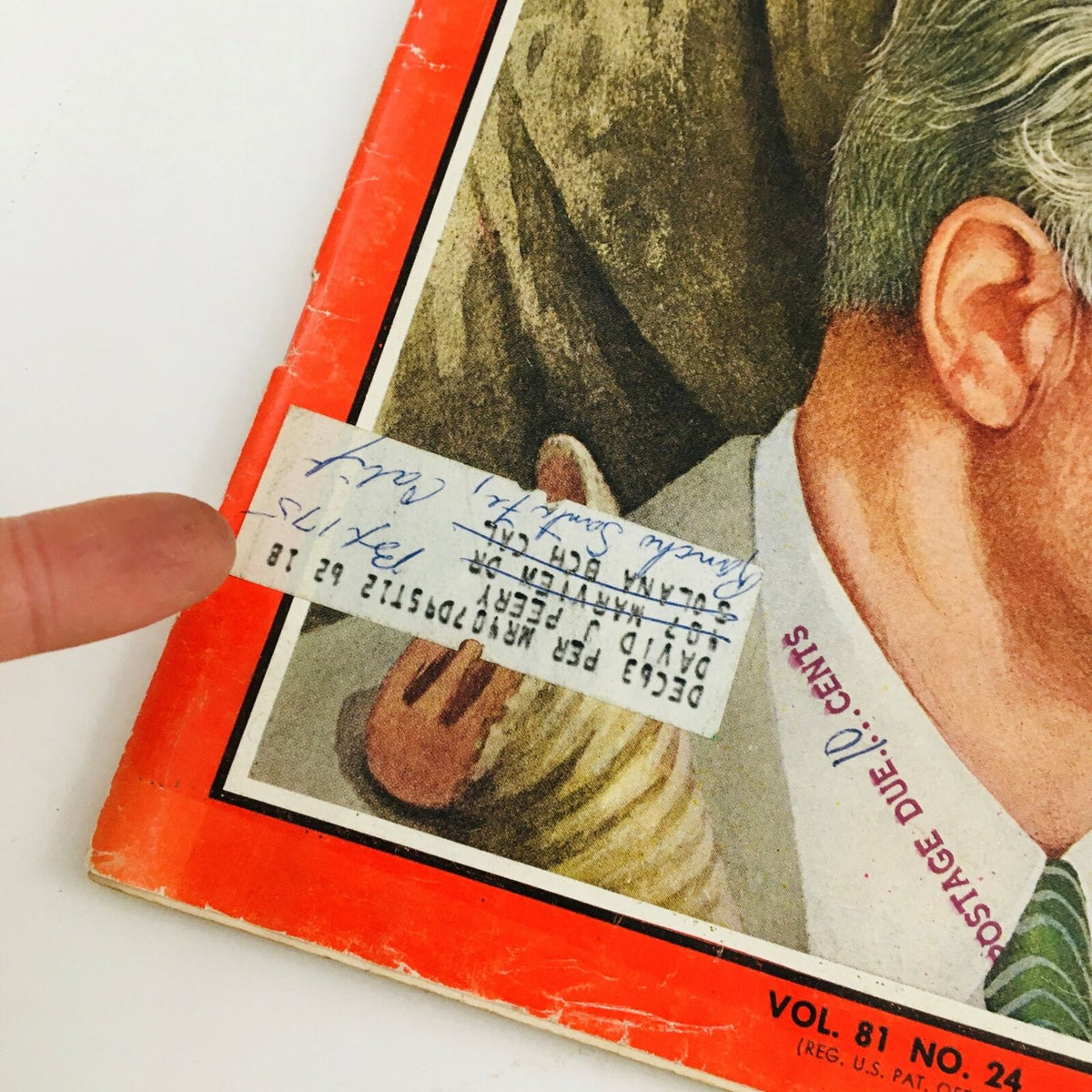 Close-up view of the vintage Time Magazine from June 14, 1963, featuring Barry Goldwater, showcasing a postage due label and handwritten notes on the cover.