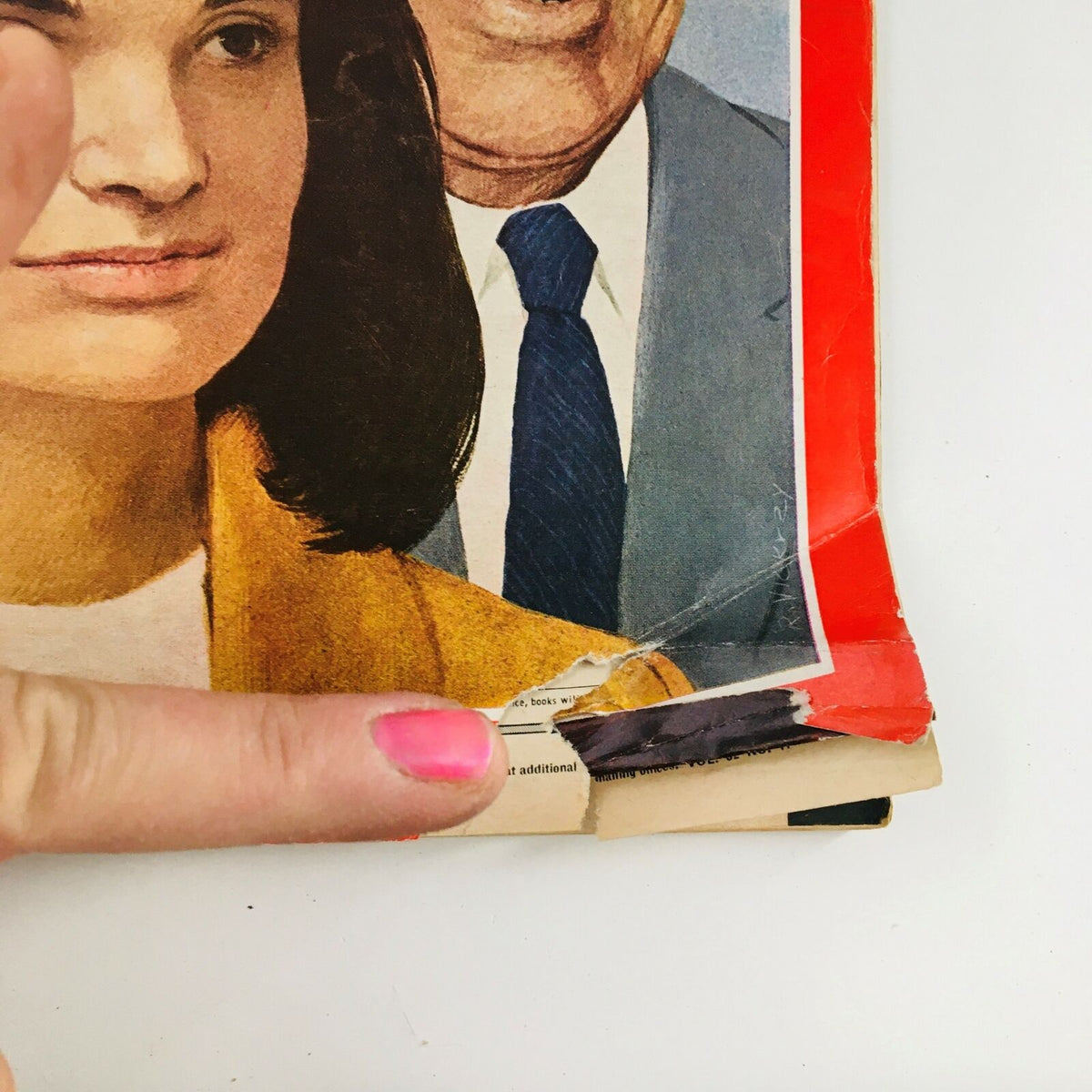 Close-up of the damaged corner of the October 25, 1968 Time Magazine cover featuring Jacqueline Kennedy and Aristotle Onassis, highlighting the wear and tear of this historical collectible.