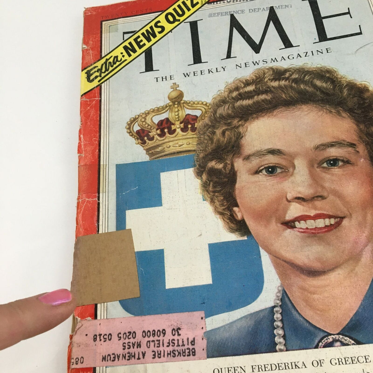 Close-up view of Time Magazine October 26 1953 cover showing Queen Frederika of Greece. The image highlights the magazine's condition, including a peeling address label and a sticker that says 'Extra: NEWS QUIZ'.