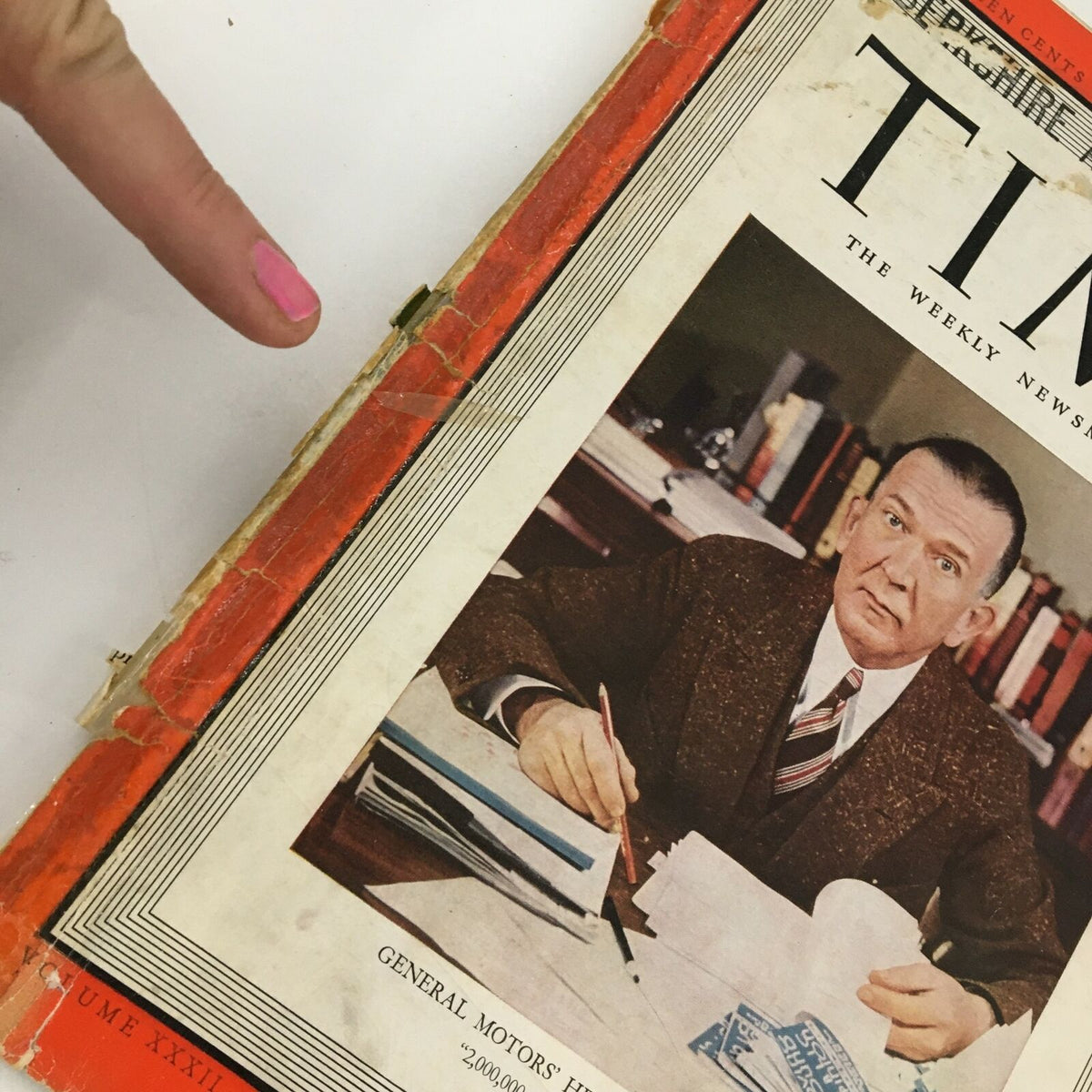 Close-up view of the Time Magazine cover from November 14, 1938, showing wear and tear with a focus on General Motors' Henry Grady Weaver's portrait.
