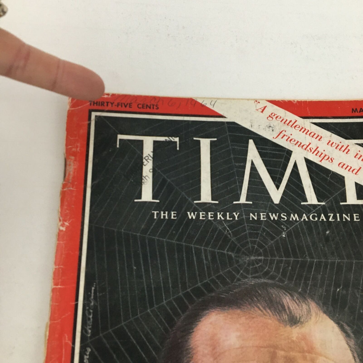 Close-up view of Time Magazine March 6, 1964, featuring the price and an inscription along the magazine cover.