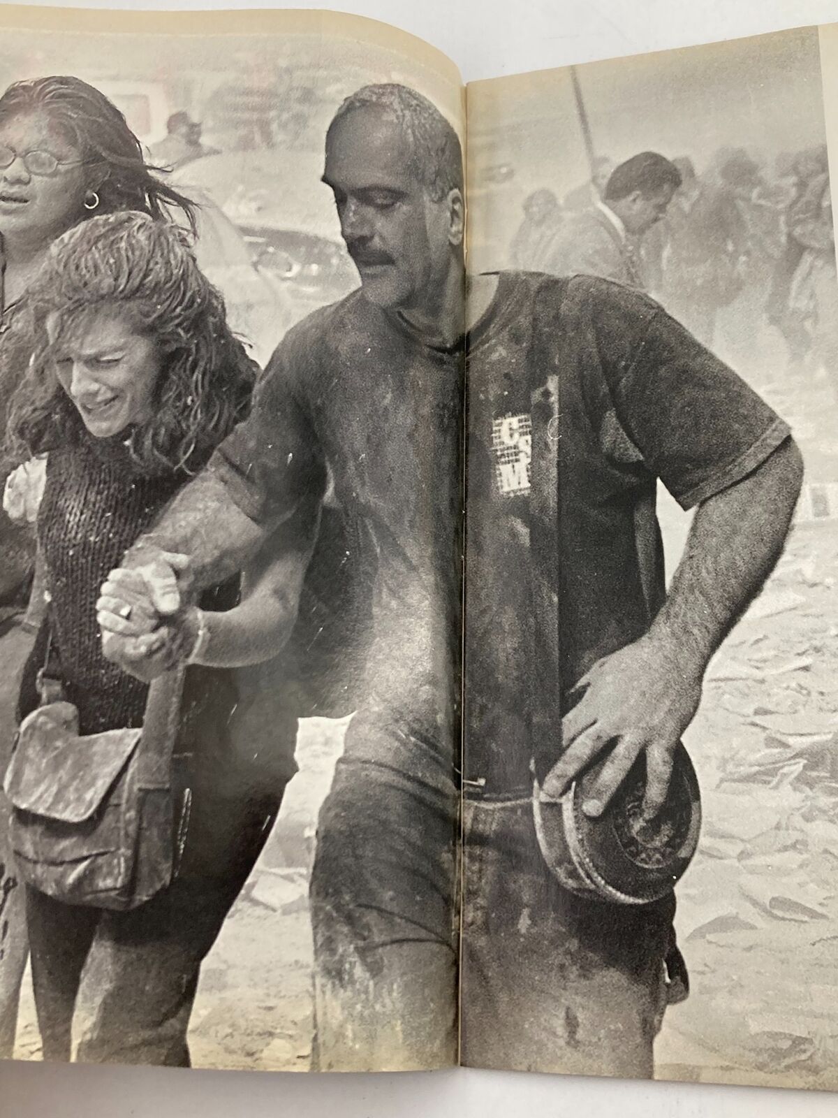Time Magazine September 11 2001 The Twin Tower Attack 9-11 - A dramatic image of a man and woman assisting each other amidst the aftermath of the Twin Towers attack.
