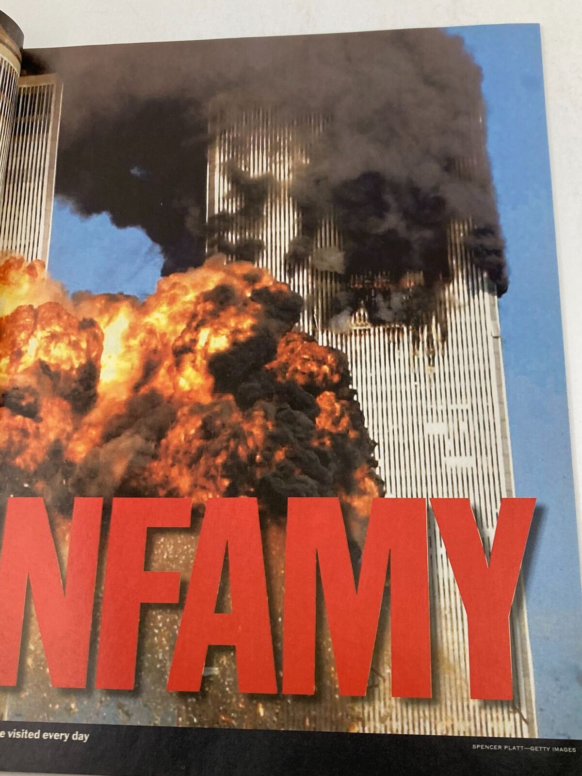Time Magazine September 11 2001 The Twin Tower Attack 9-11 - A striking image of the Twin Towers engulfed in flames with the word 'INFAMY' prominently displayed.