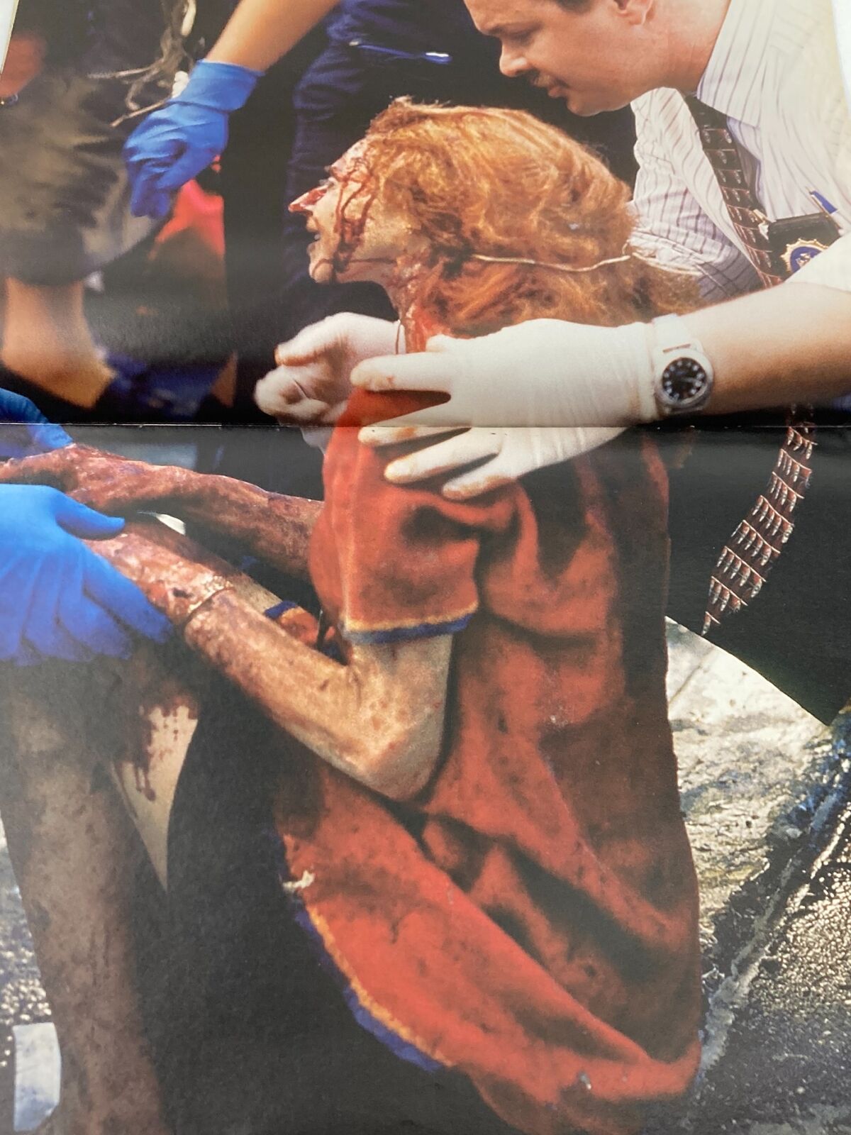 Time Magazine September 11 2001 The Twin Tower Attack 9-11 - A haunting photograph of a woman injured and being assisted by responders after the Twin Towers attack.