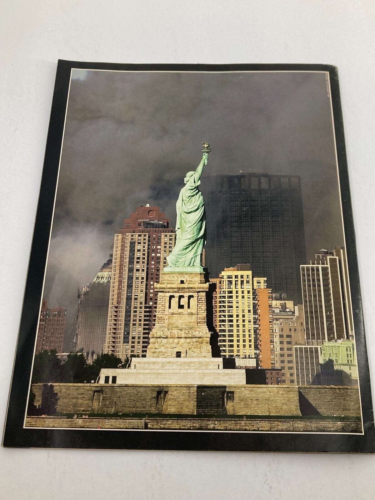 Statue of Liberty surrounded by dark clouds, symbolizing the aftermath of the September 11 attacks, featured in Time Magazine September 11 2001 The Twin Tower Attack 9-11.