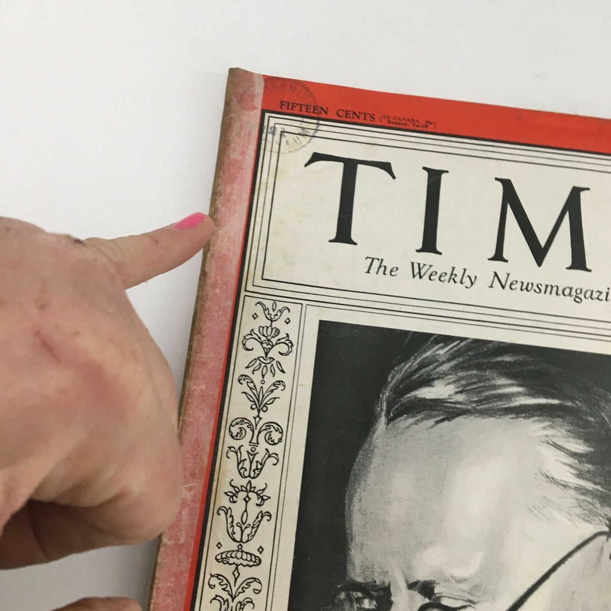 Close-up of the Time Magazine cover from April 24, 1933, featuring a finger pointing at the top edge. The magazine showcases Foreign Commissar Maxim Litvinov, with visible signs of age including minor wear, highlighting its historical significance.