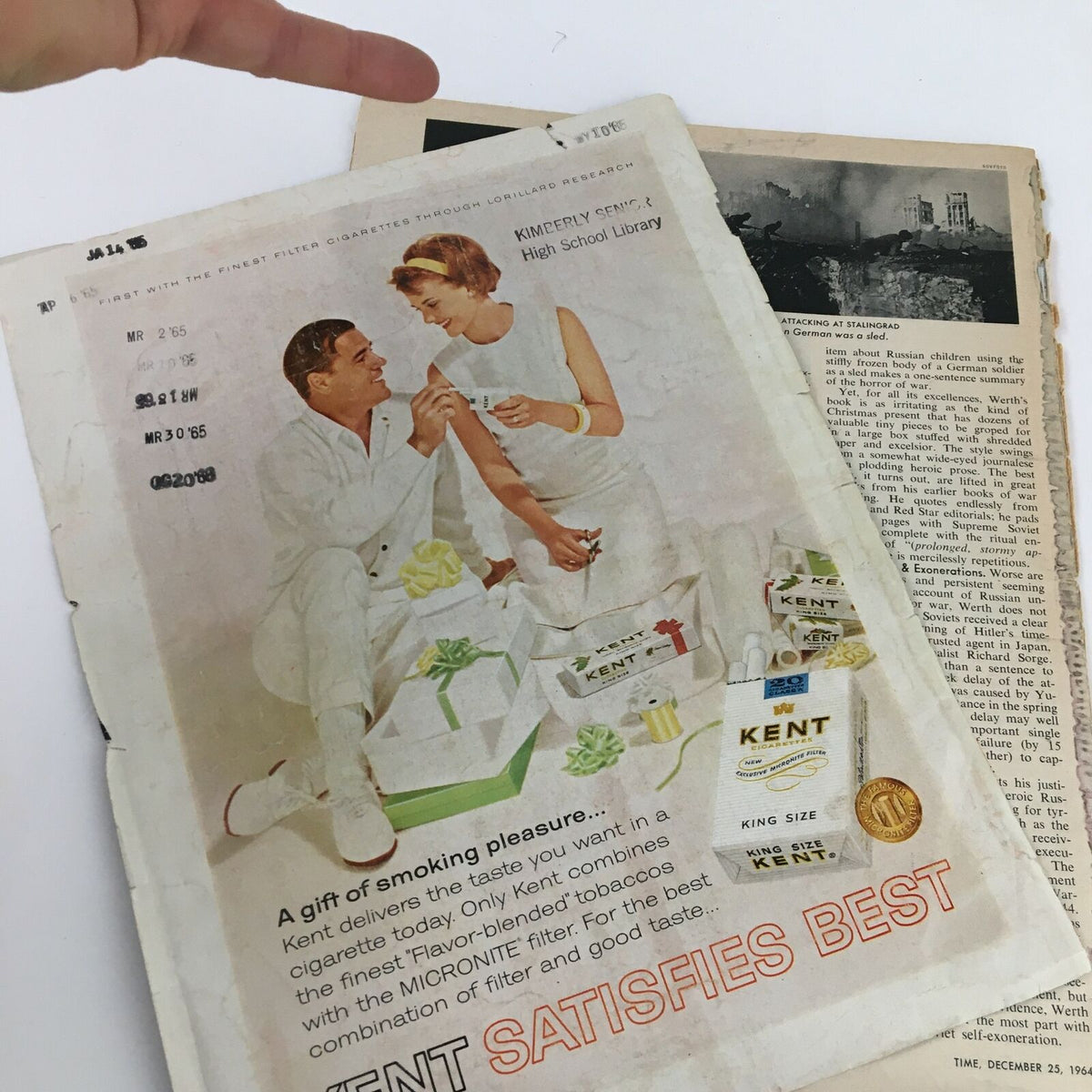 Inside page of Time Magazine Vol 84 No. 26, December 25 1964, featuring an advertisement for Kent cigarettes, marked with a library stamp.