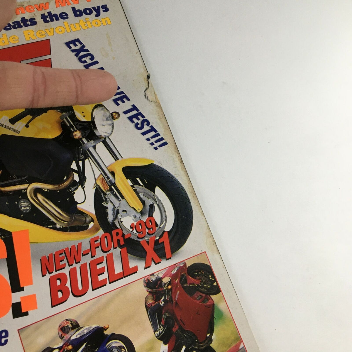 Detail view of the Cycle World Magazine September 1998 cover emphasizing the Buell X-1 with the text 'NEW-FOR-99' and images of motorcycles performing stunts.