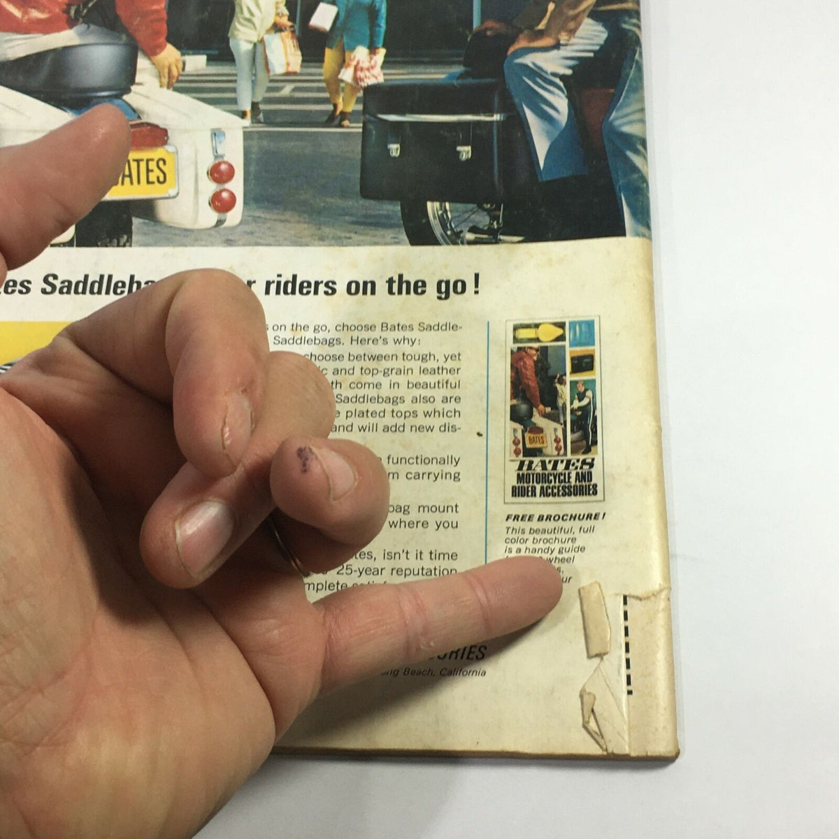 Back cover of VTG Cycle Magazine February 1969 displaying a hand gesture near an advertisement for Bates Motorcycle Accessories, emphasizing vintage motorcycle culture.