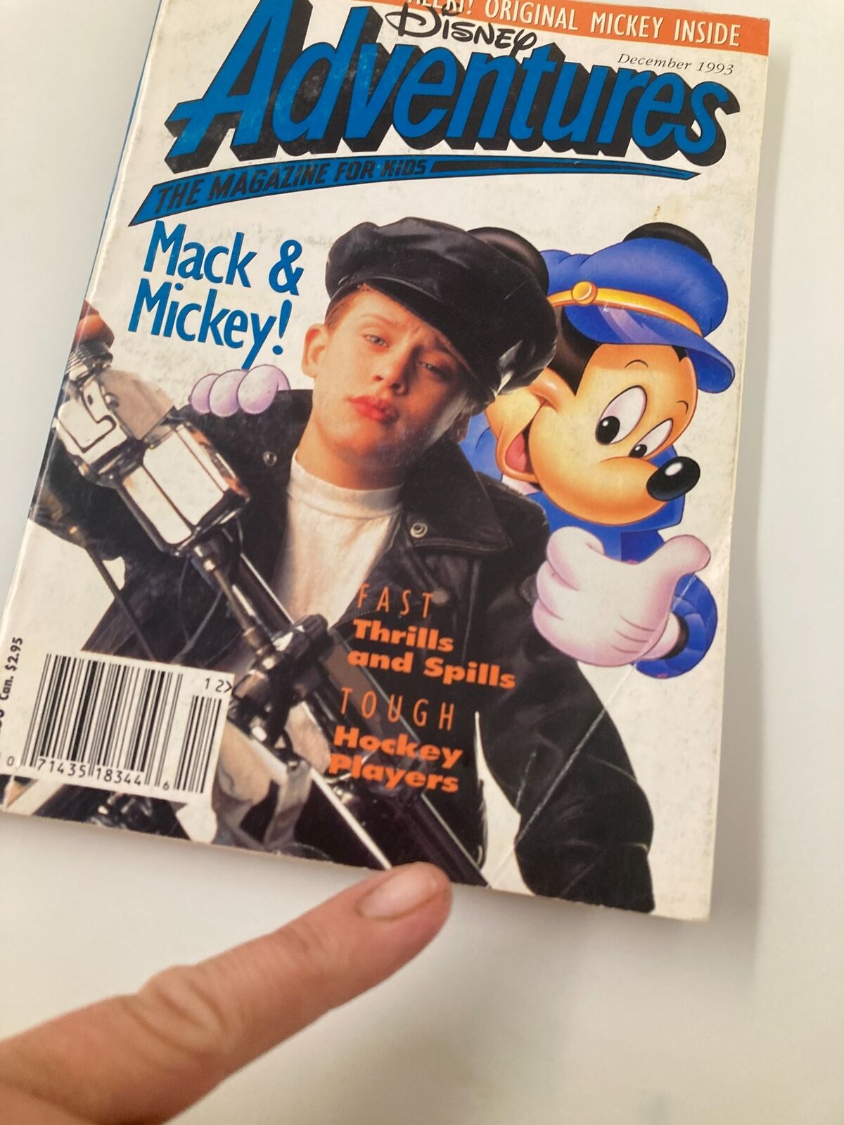 Close-up view of Disney Adventures Magazine December 1993 cover, highlighting Macaulay Culkin in a leather jacket alongside Mickey Mouse, emphasizing its collectible nature.