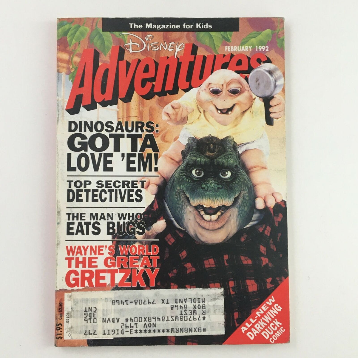 Cover of Disney Adventures Magazine, February 1992 featuring a playful dinosaur character, a baby with a magnifying glass, and prominent text highlighting stories about dinosaurs, Wayne's World, and Wayne Gretzky.