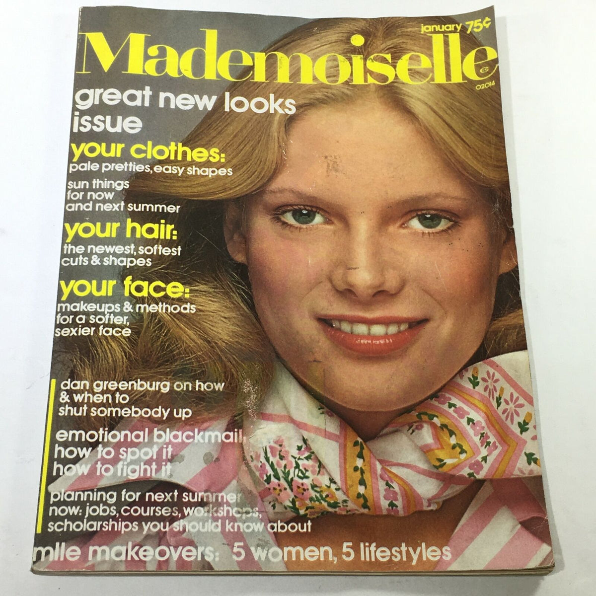 Cover of VTG Mademoiselle Magazine: January 1975 - Great New Looks Issue featuring a smiling model with blonde hair and green eyes, adorned with a floral neck scarf and surrounded by text highlighting fashion topics such as clothing, hair, and makeup.