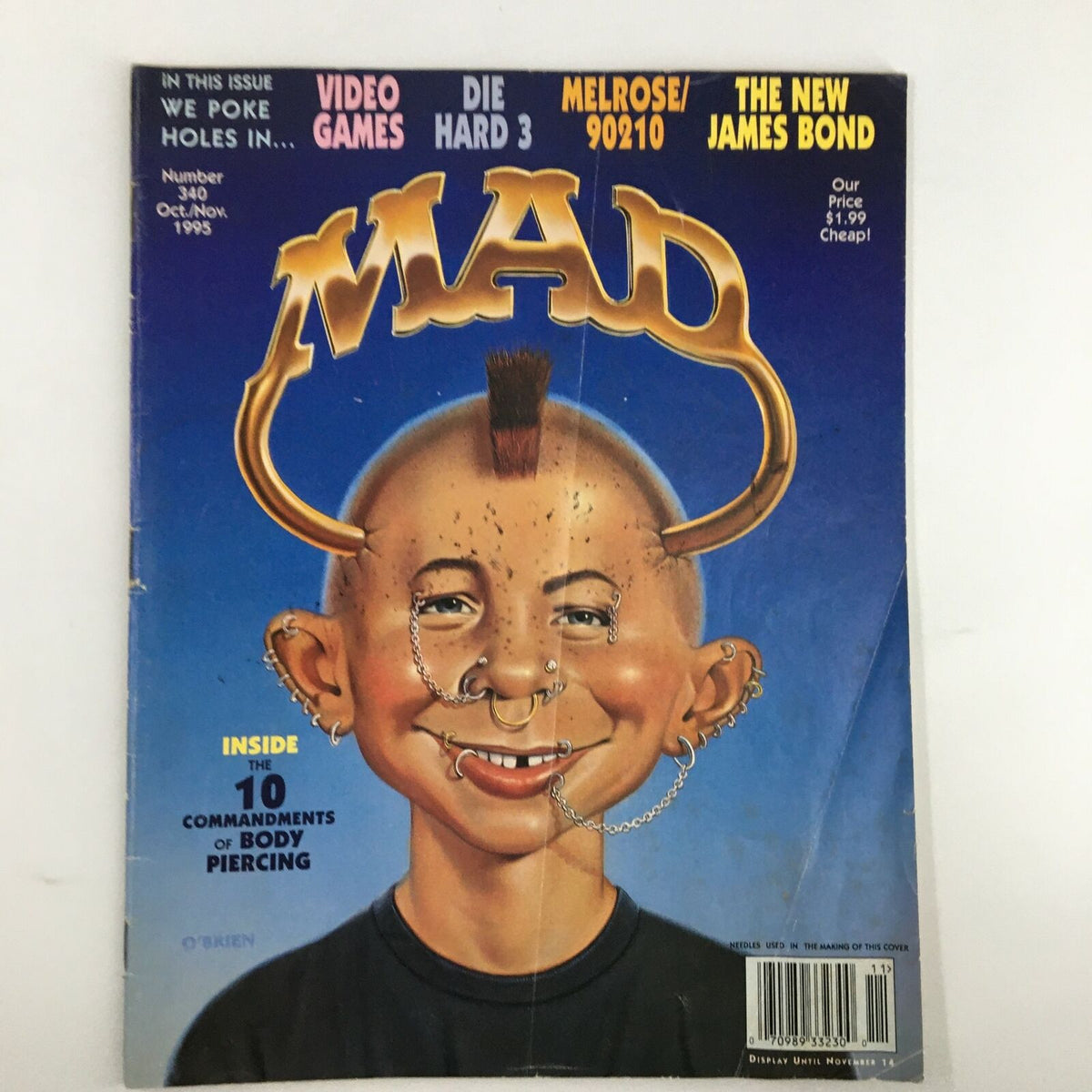 Cover of Mad Magazine October 1995 featuring a humorous illustration related to the 10 Commandments of Body Piercing, showcasing a character with various piercings and a mohawk hairstyle.