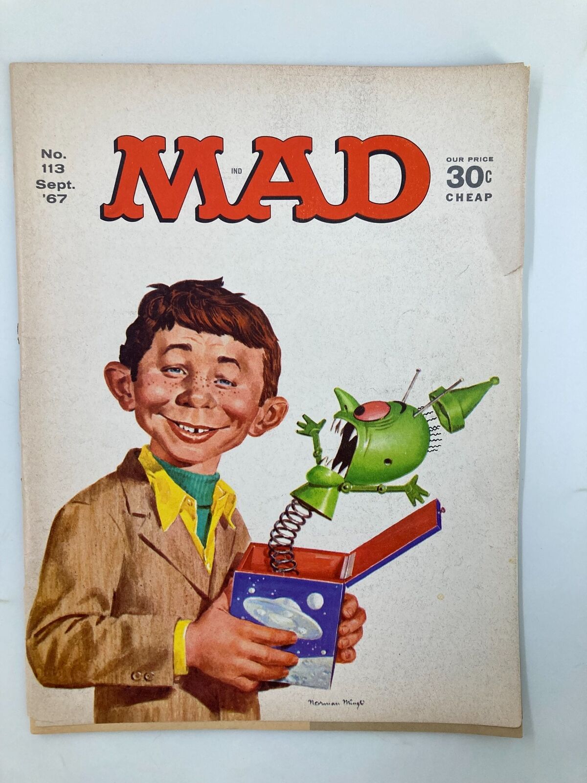 Cover of Mad Magazine September 1967 No. 113 featuring a character with a surprised expression holding a jack-in-the-box styled green alien. This vintage comic book is in Very Good condition and showcases the distinctive artwork unique to Mad Magazine.