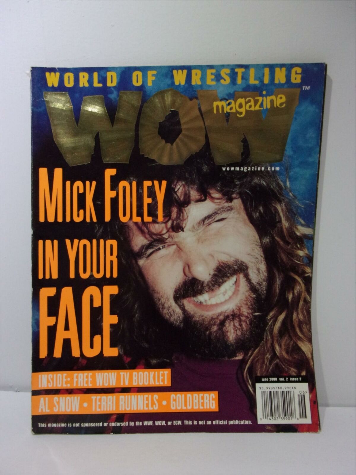 Cover of World of Wrestling WOW Magazine featuring Mick Foley In Your Face, showcasing the legendary wrestler with vibrant graphics and bold text highlighting the issue's focus on wrestling personalities from the era.