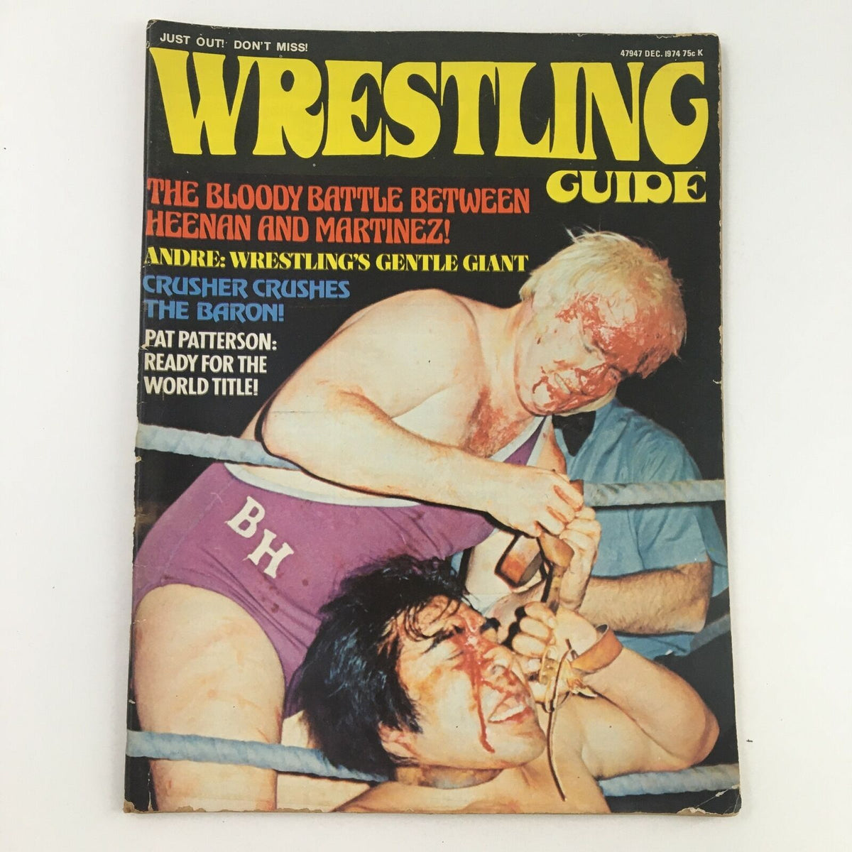 Cover of Wrestling Guide Magazine December 1974 featuring a dramatic wrestling match between Bobby Heenan and Luis Martinez, highlighting intense action and iconic wrestling personalities.