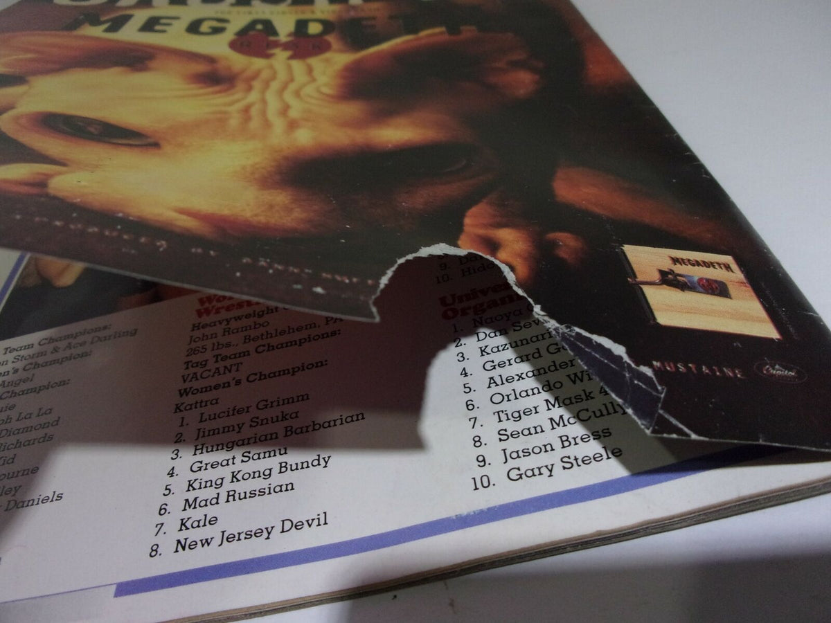 Close-up of the back cover of 'Ringside Wrestling: Undertaker "I'll drink Austin's Blood" October 1999', highlighting content details and a notable corner tear.