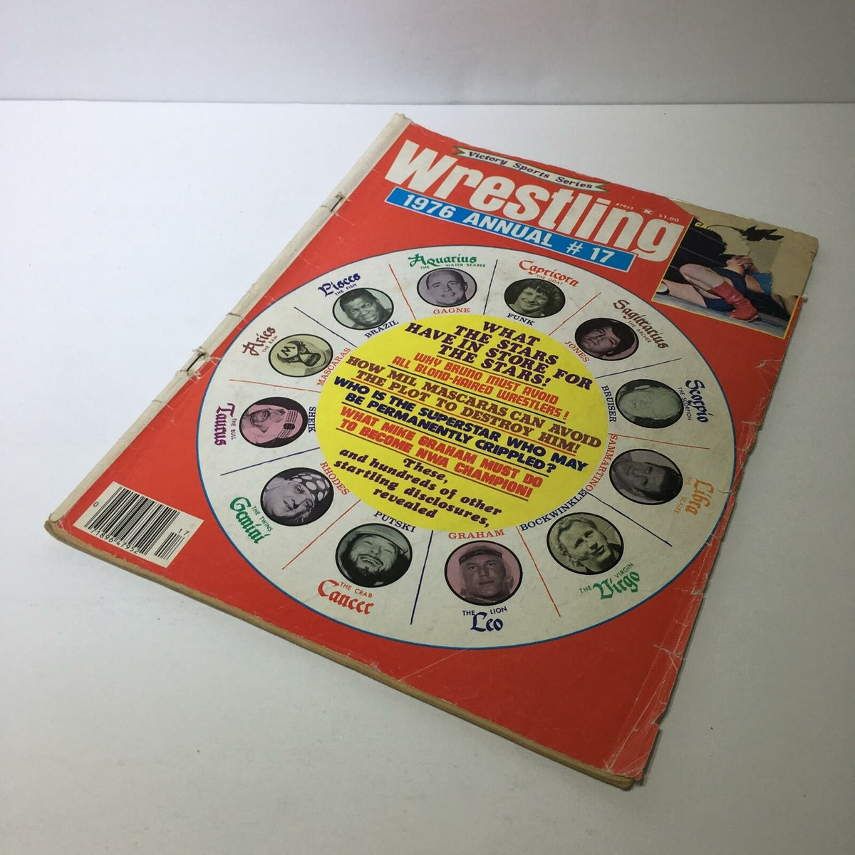 Side view of the front cover of Wrestling 1976 Annual #17 - What the Stars Have in Store for the Stars, displaying iconic wrestling graphics and horoscopes.