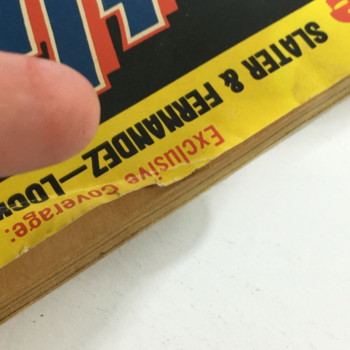 Close-up of the worn edge of the VTG Inside Wrestling Magazine July 1981, showing minor damage and exclusive coverage details.