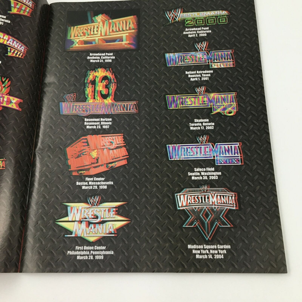 Page from WWE Present 2004 Wrestle Mania magazine displaying various Wrestle Mania logos and dates, emphasizing its rich wrestling history.