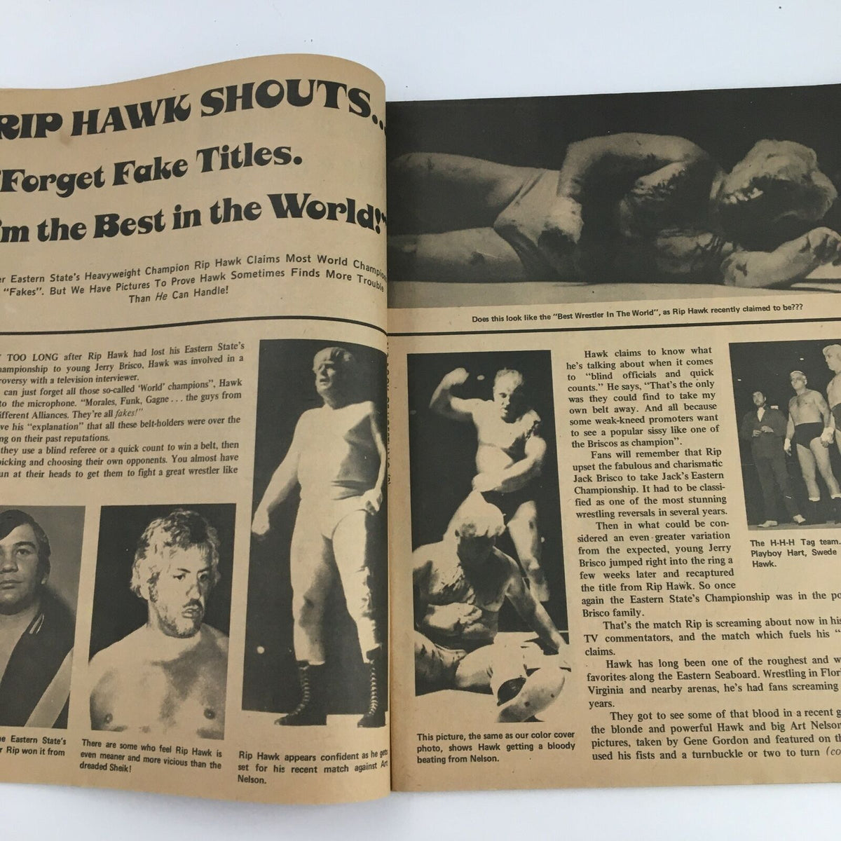A detailed page from 'The Big Book of Wrestling' May 1973 showcasing Rip Hawk’s bold claim on wrestling titles, alongside photos of wrestlers, reflecting the style and culture of wrestling in that time.