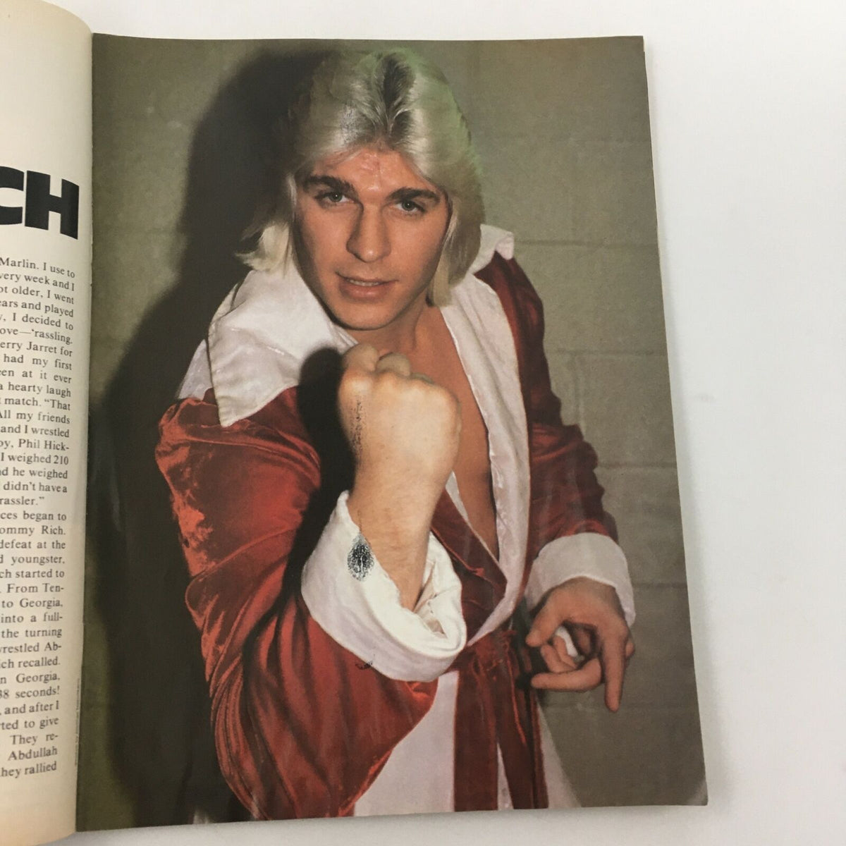 Color image of wrestler Tommy Rich posing confidently in a red robe, featured in Wrestling's Main Event Magazine October 1982. A representation of the charisma and style of wrestling stars from that era.