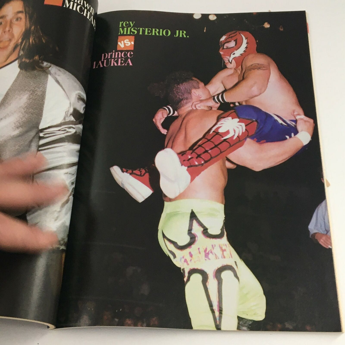 Action shot from Wrestling Yearbook Winter 1997 showing Rey Mysterio Jr. versus Prince Iaukea, highlighting the dynamic moves of professional wrestling.
