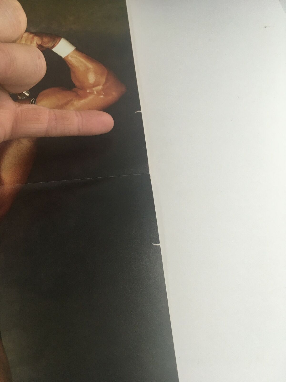 Inside page of Pro Wrestling Illustrated July 1996 showing a close-up of Lex Luger's muscular arm, with a focusing finger indicating the detail of the magazine's content. Features include minor wear consistent with age.