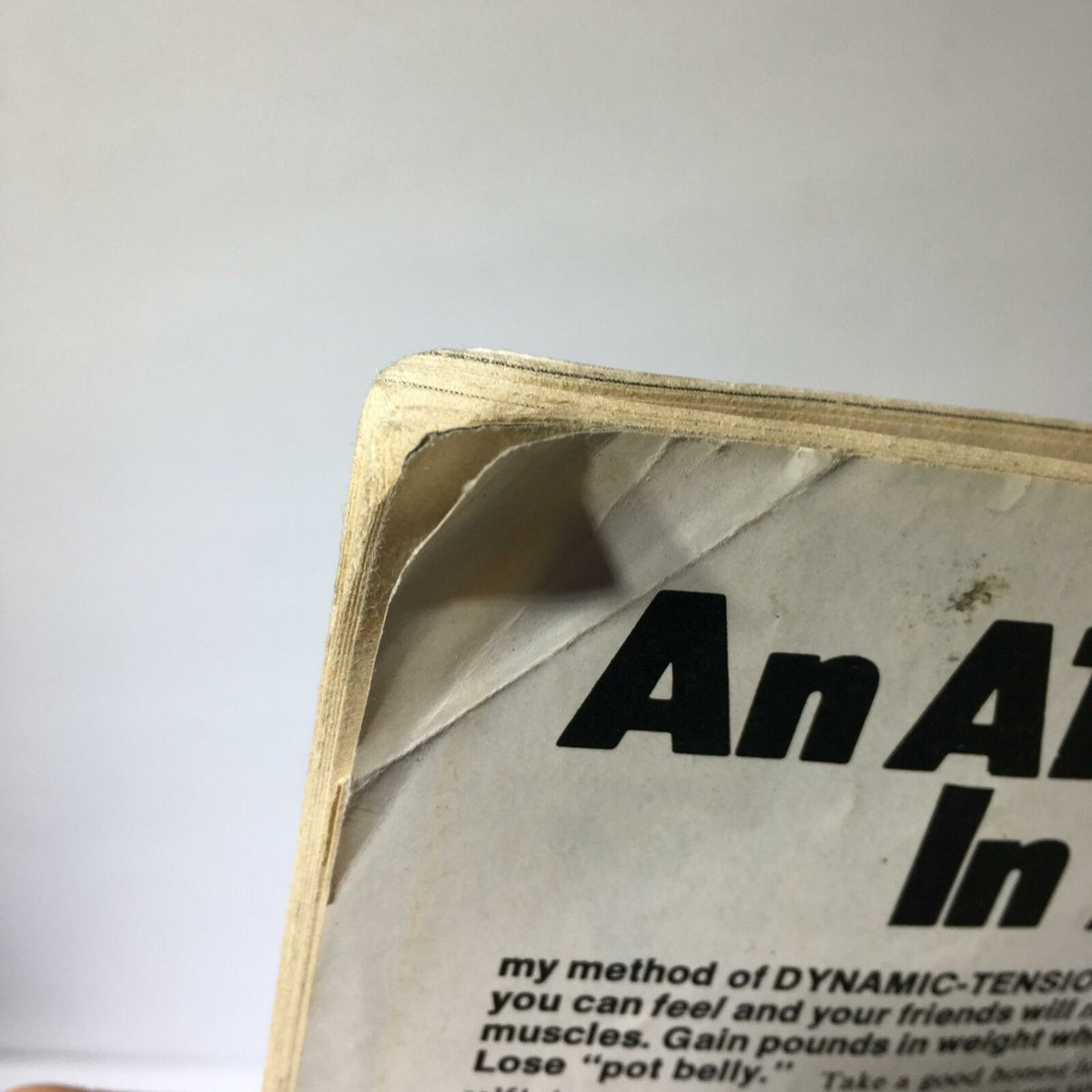 Top edge of the back cover of Inside Wrestling Magazine, September 1977, displaying slight damage and wear signs.