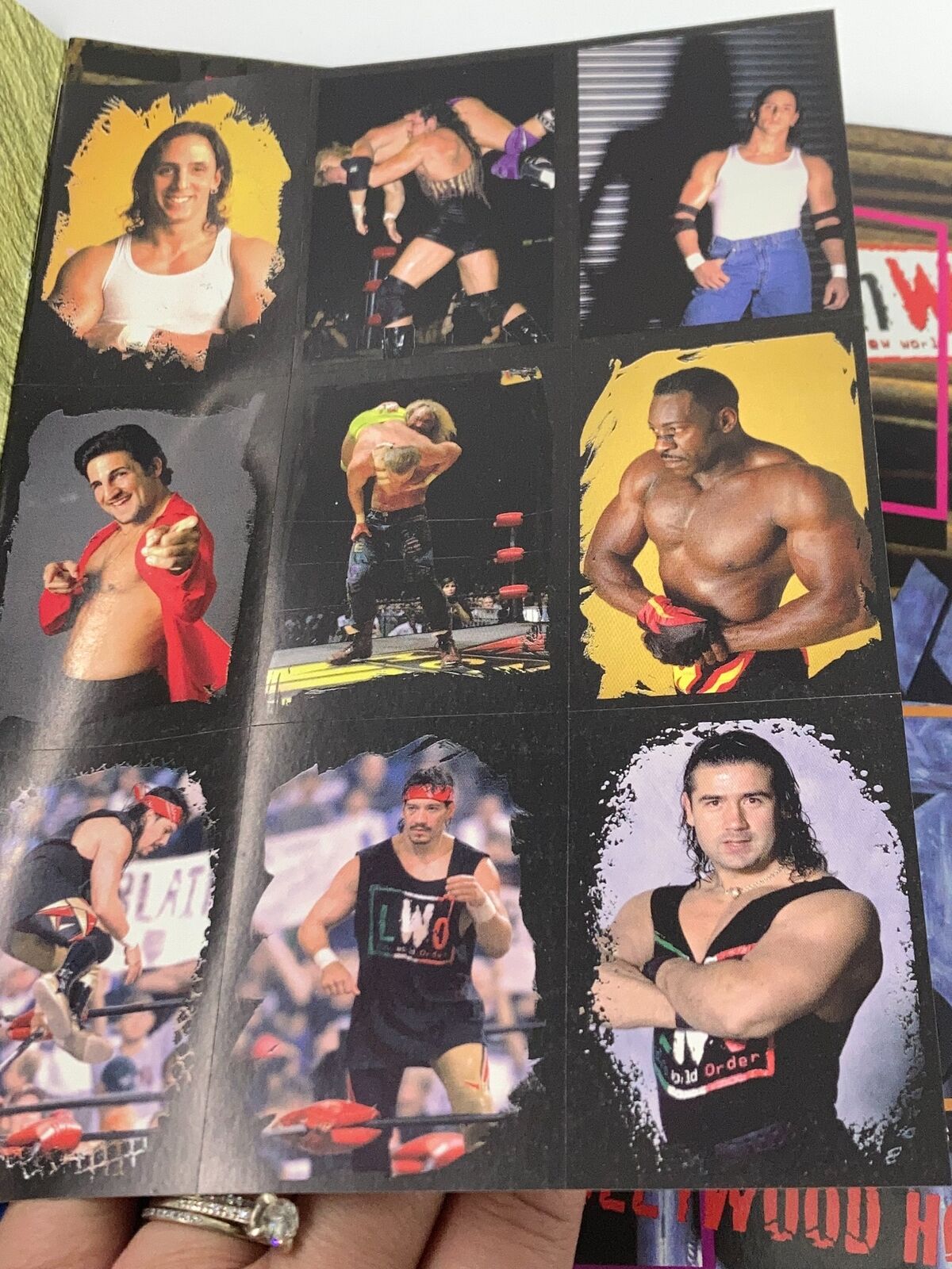 Inside page of the 1999 WCW and NWO Sticker Book showcasing various wrestlers including styles and action shots.