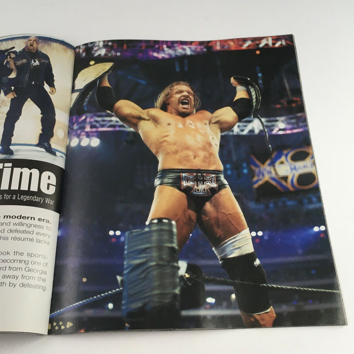 WWE Raw Magazine June 2003 features Triple H celebrating victory with championship belts, capturing the excitement of WWE matches.