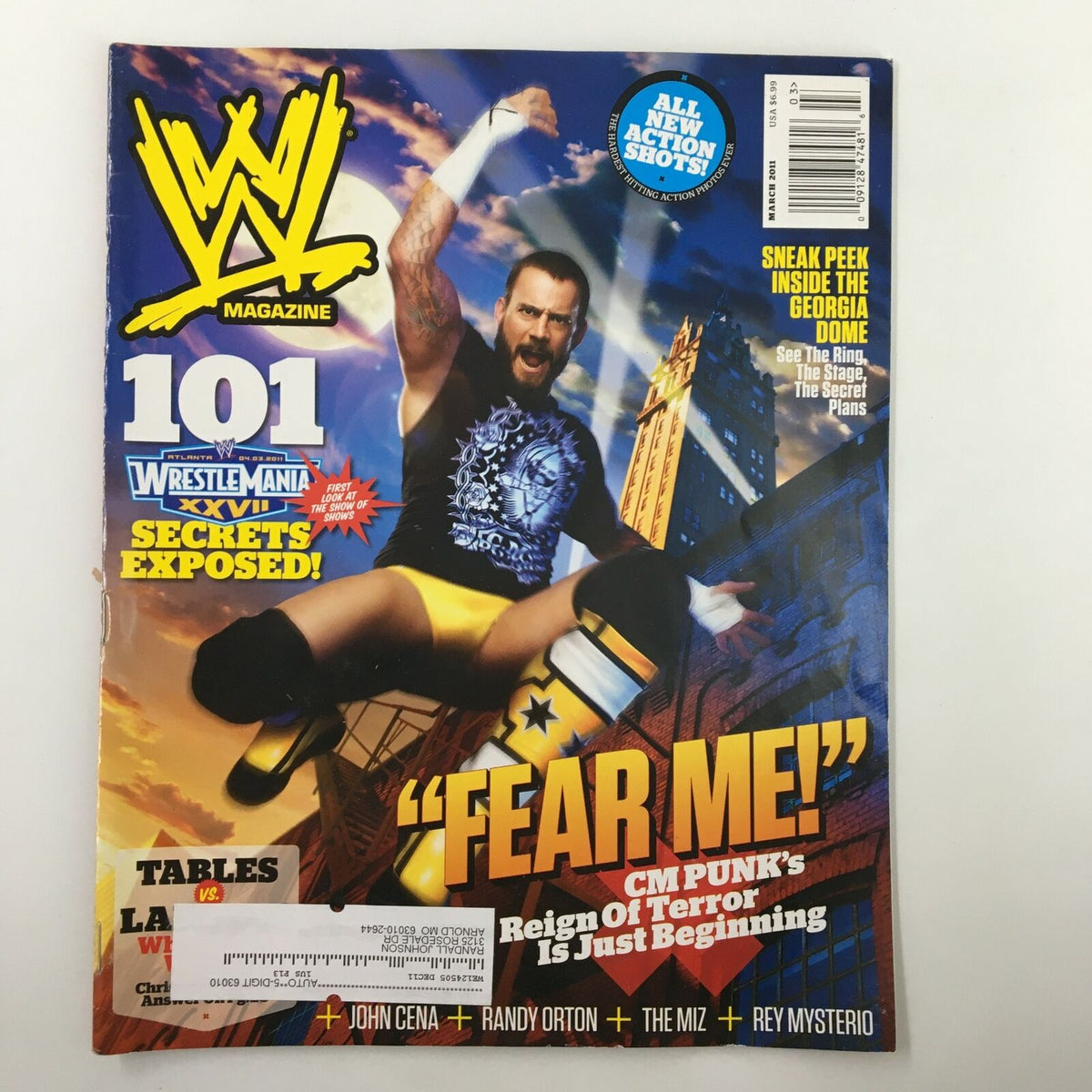 WWE Magazine March 2011 cover featuring CM Punk in a wrestling pose, highlighting the theme 'Fear Me! CM Punk's Reign of Terror Is Just Beginning.' The magazine showcases vibrant graphics and promotes its exclusive WWE content.