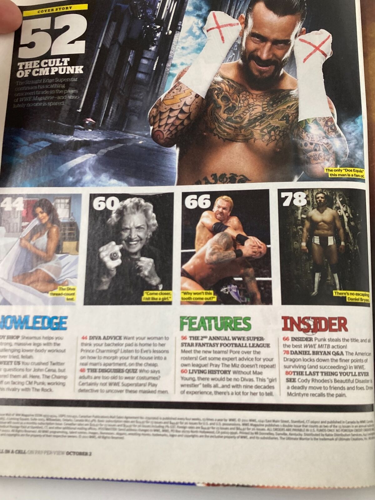 Inside page of WWE Magazine October 2011 showcasing content about CM Punk, features on wrestling legends, and fantasy football strategies.