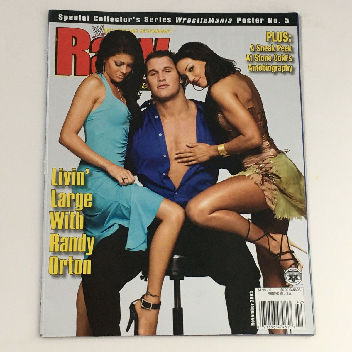 Cover of WWE Raw Magazine November 2003 featuring Randy Orton with two models, highlighting his prominence in wrestling and pop culture.