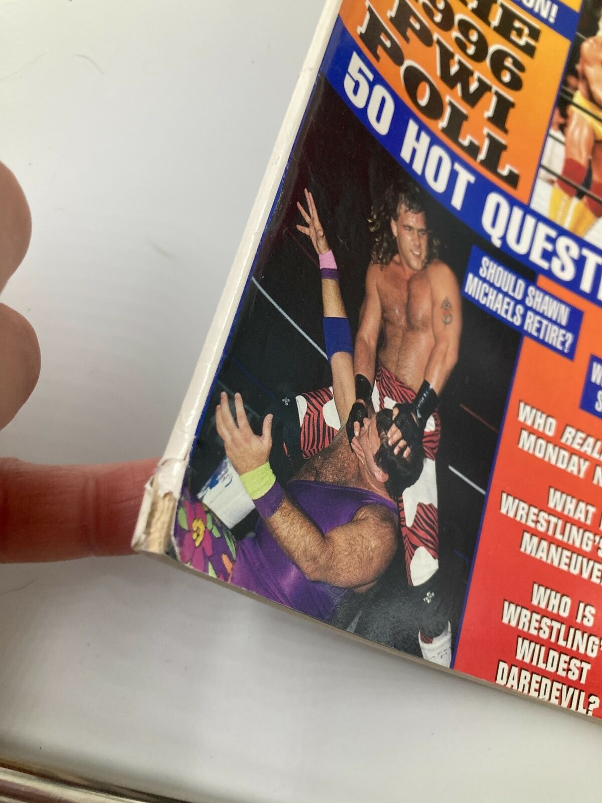 Close-up of the edge of Pro Wrestling Illustrated Magazine June 1996 showcasing minor wear and tear, highlighting its vintage condition.