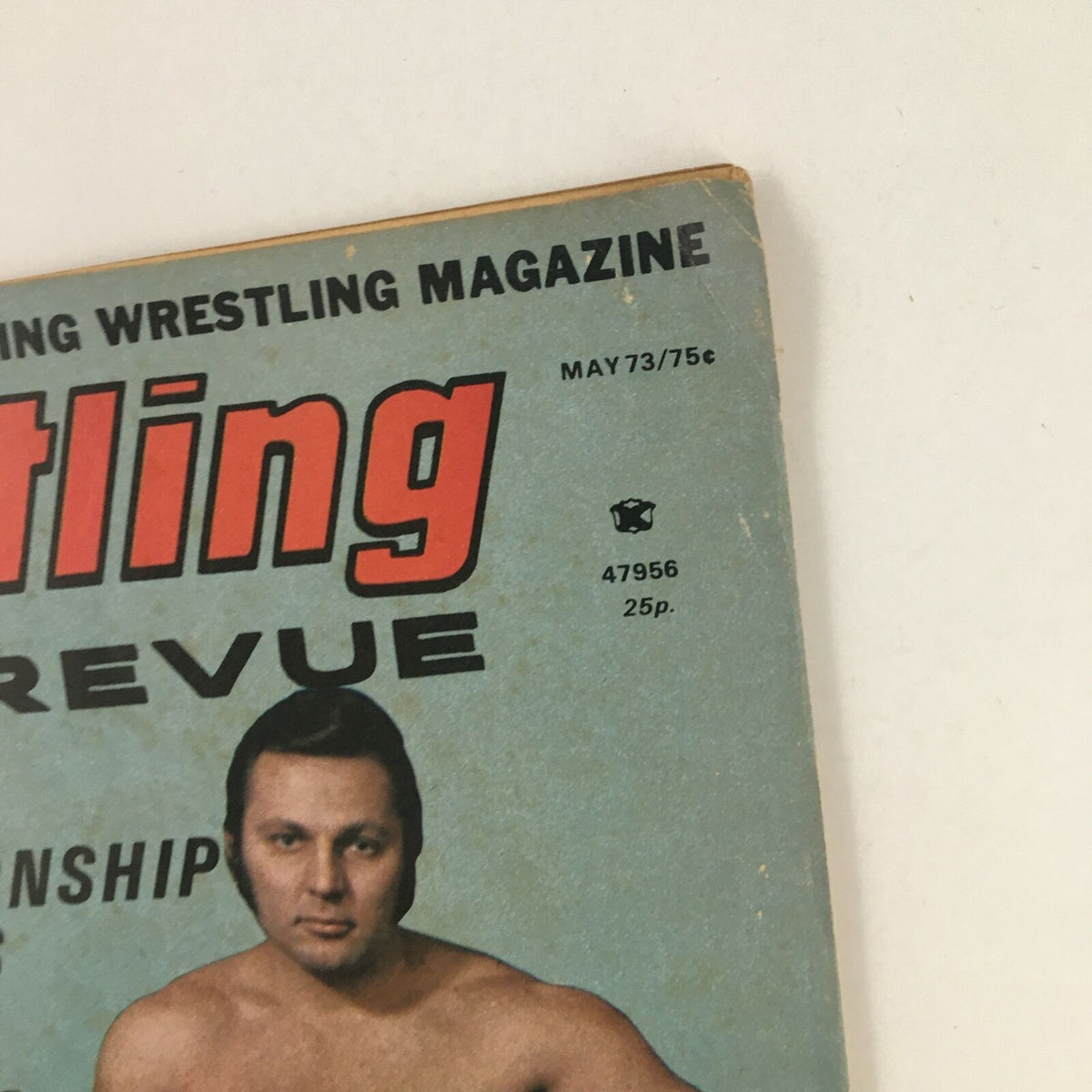 Detailed shot of the top corner of the Wrestling Revue Magazine May 1973, displaying the publication title and print date, focusing on its vintage wrestling magazine design.