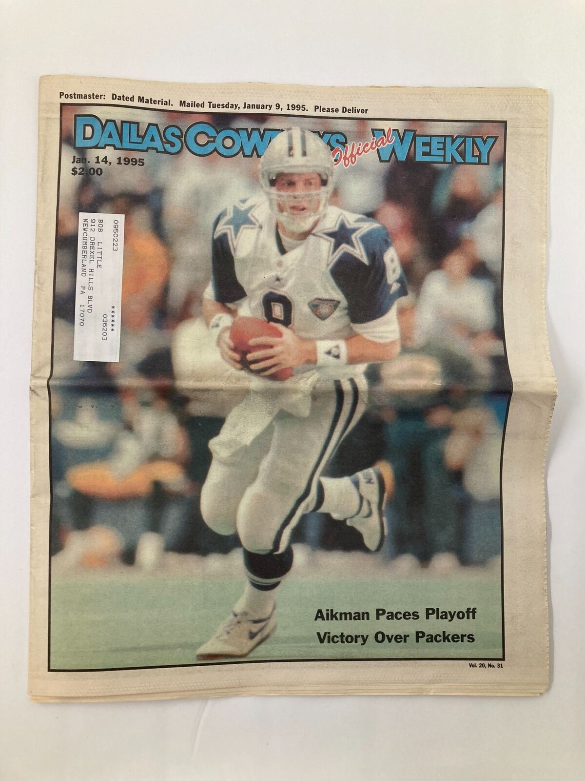 Dallas Cowboys Weekly Newspaper January 14 1995 Vol 20 #31 featuring Troy Aikman on the cover, showcasing him in action during the playoffs against the Packers. Good condition with minor wear, comes with a protective covering.